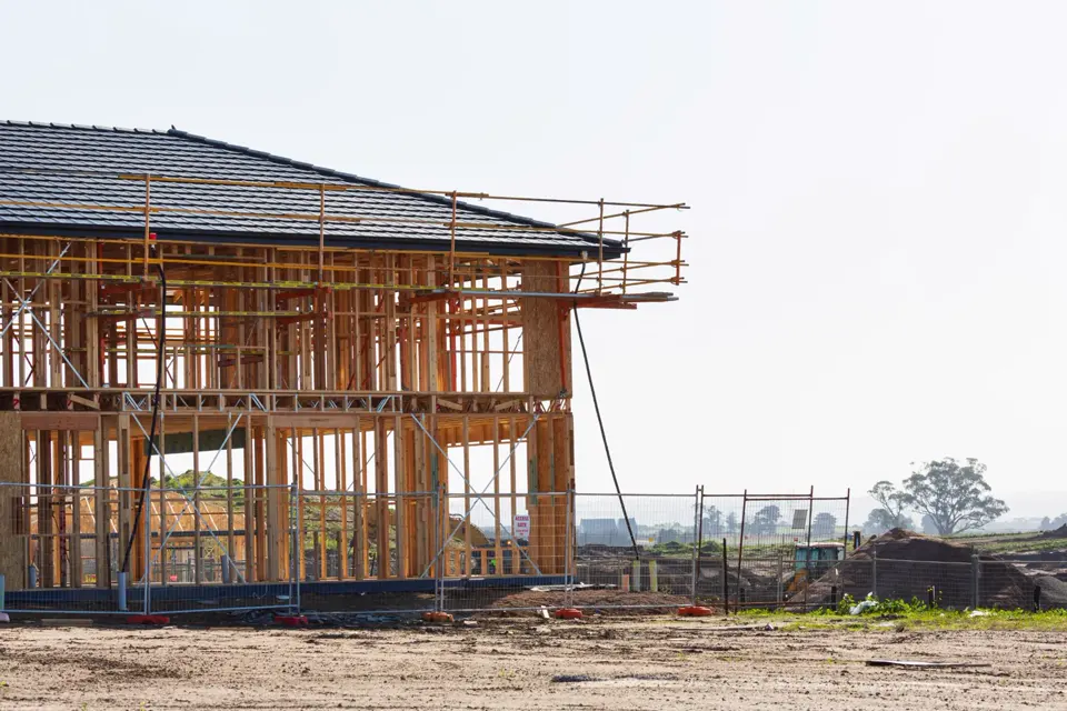 Framed two-story structure with a finished roofline and edge safety rails